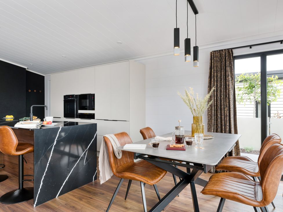 A kitchen with a table and chairs at Costal Lodge at Seaham Hall Seaham