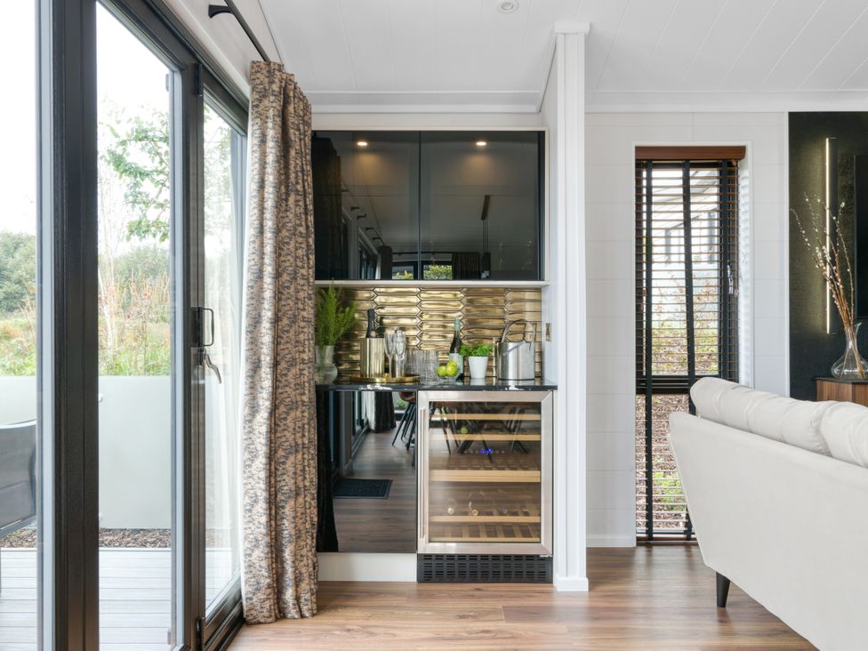 A kitchen with a bar area and glassware at Costal Lodge at Seaham Hall, Seaham