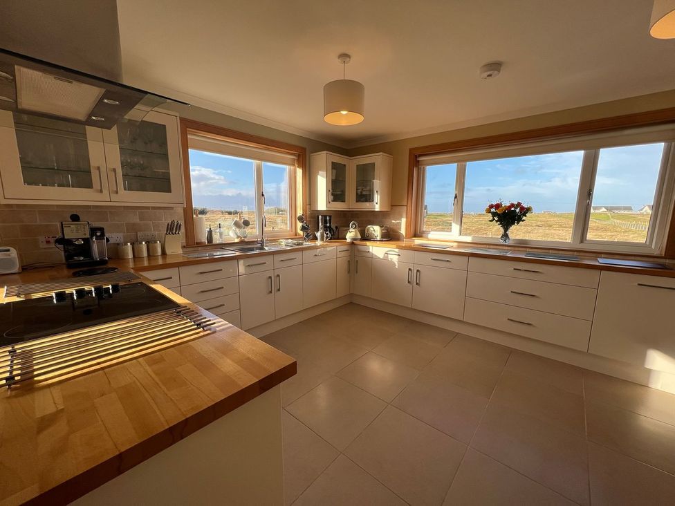 A kitchen with a sink and windows at Airigh nam Fiadh in Creagorry