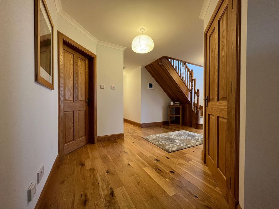 A hallway with a staircase and doors at Airigh nam Fiadh in Creagorry