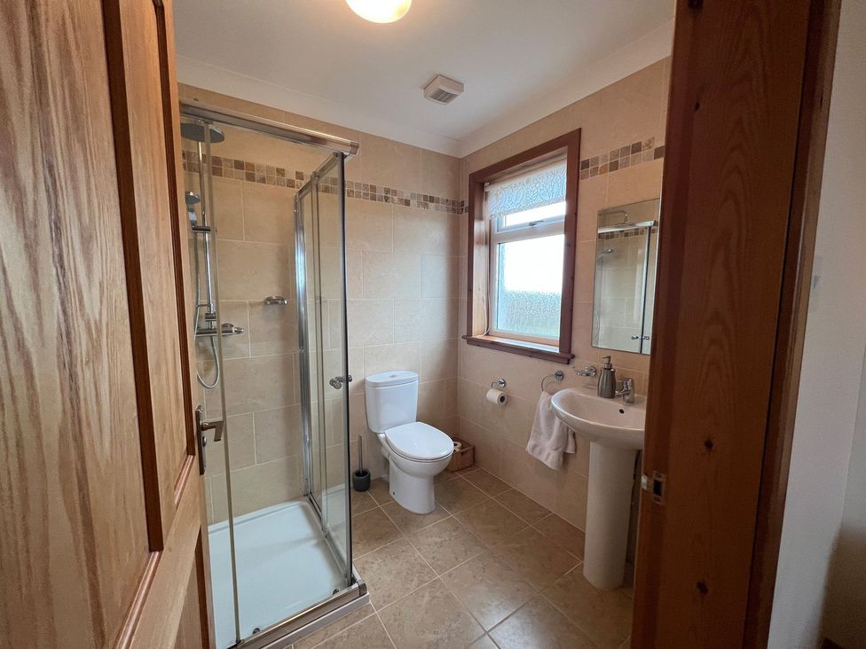 A bathroom with a shower, toilet, and sink at Airigh nam Fiadh in Creagorry