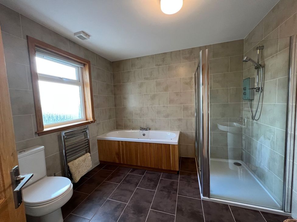 A bathroom with a bathtub, shower, and toilet at Airigh nam Fiadh in Creagorry