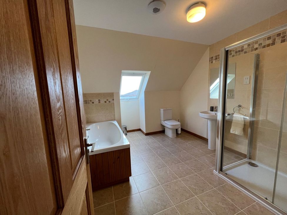 A bathroom with a bathtub, toilet, sink, and shower at Airigh nam Fiadh in Creagorry
