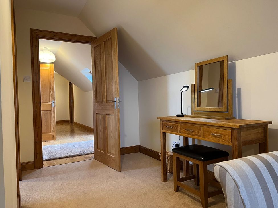 A bedroom with a desk and mirror at Airigh nam Fiadh Creagorry
