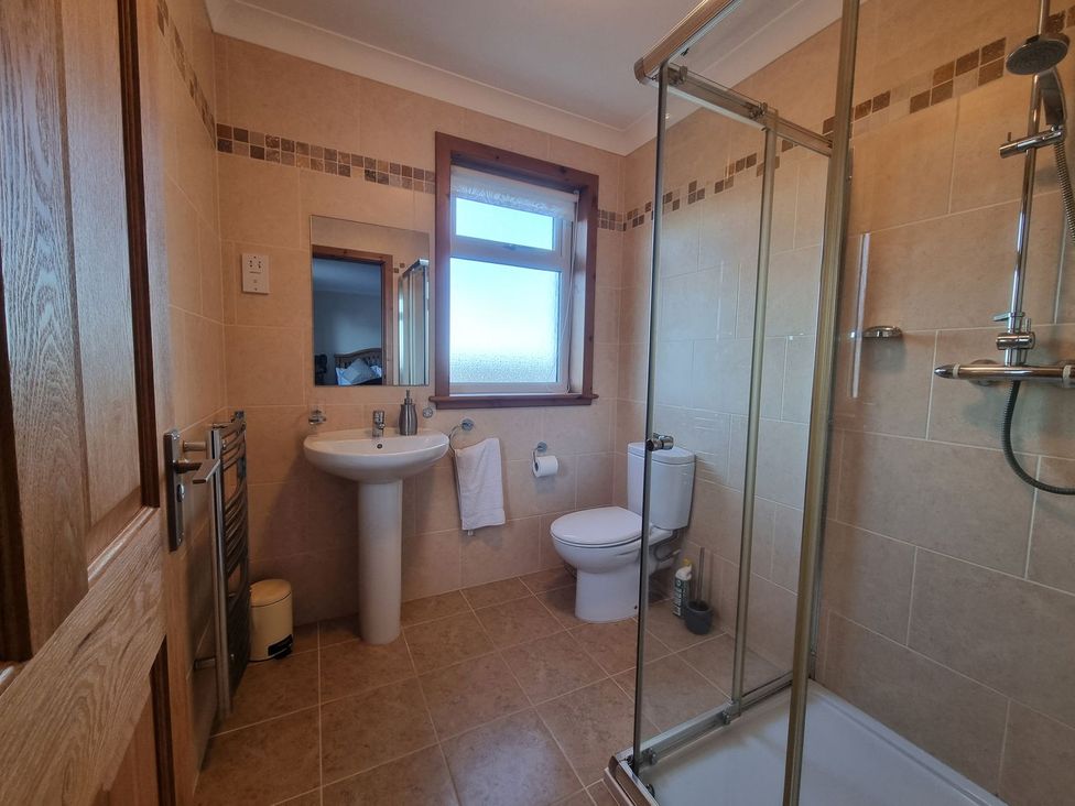 A bathroom with shower sink and toilet at Airigh nam Fiadh in Creagorry