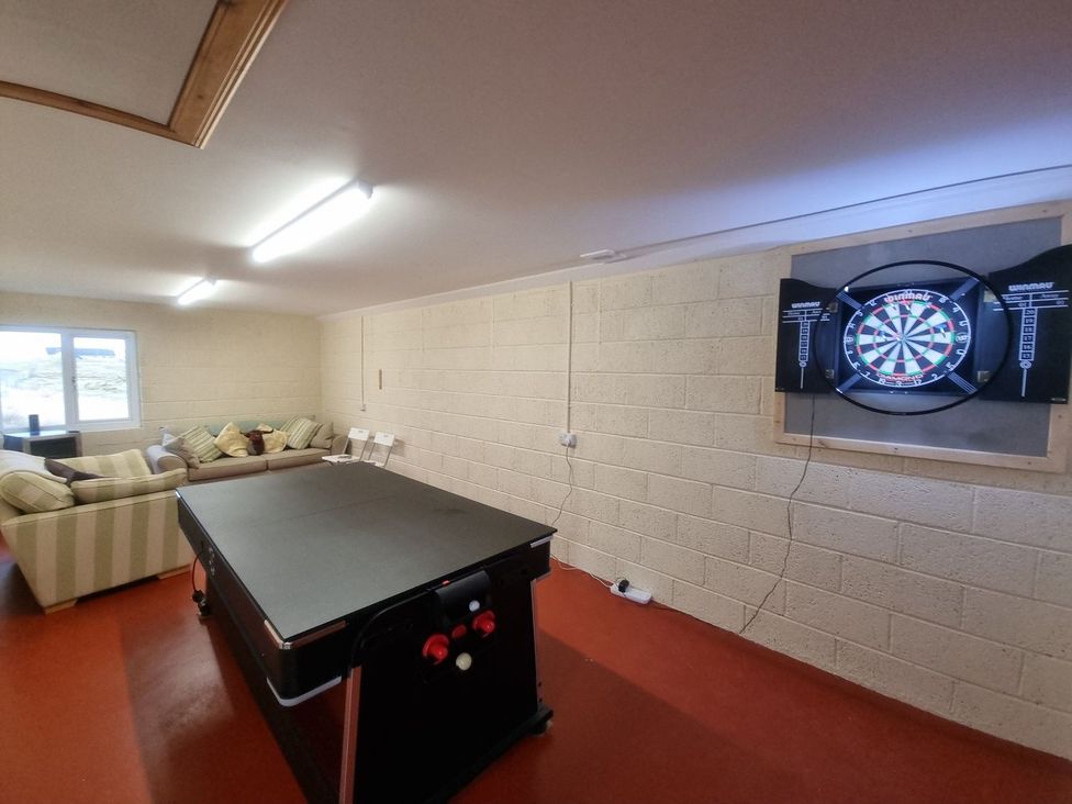 A game room with a dartboard and a table at Airigh nam Fiadh Creagorry