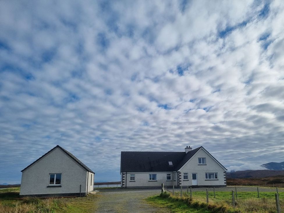 A house and garage with clouds in the sky at Airigh nam Fiadh Creagorry