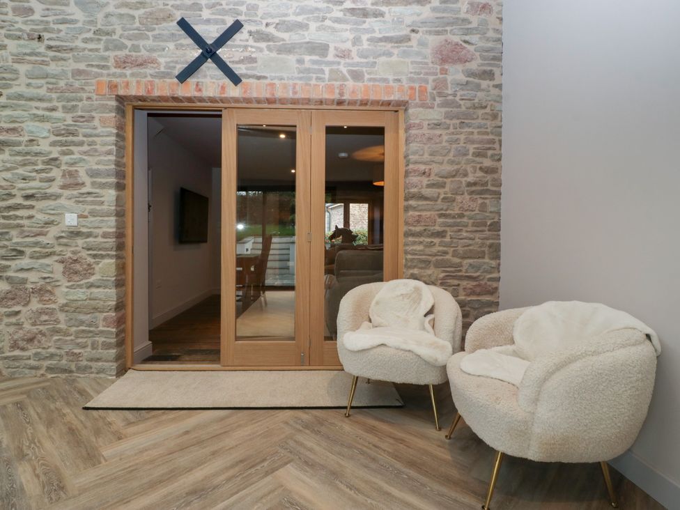 An entrance hall with double doors and two armchairs at 3 bed property