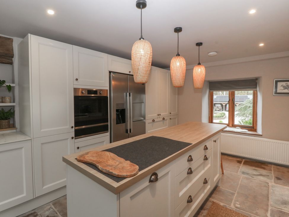 A kitchen with island, refrigerator, and oven at 3 bed property