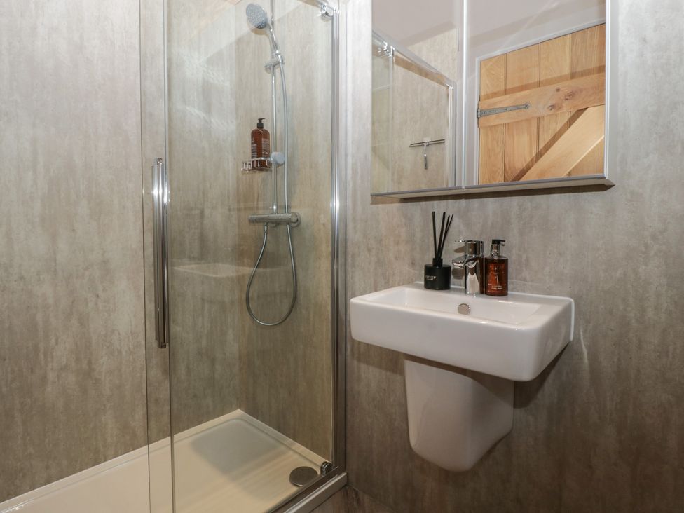 A bathroom with a shower and sink at 3 bed property