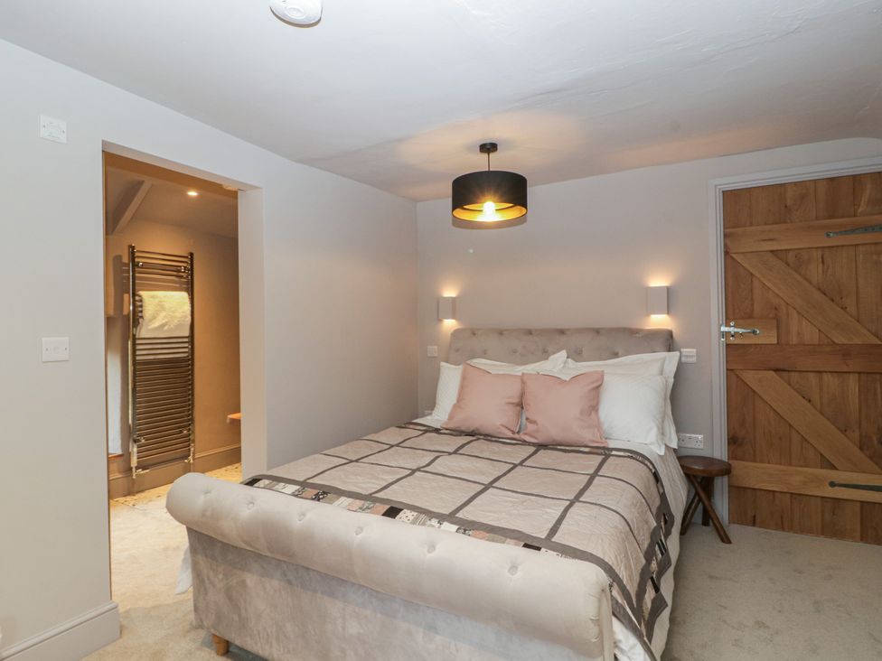 A bedroom with a bed and a towel radiator at 3 bed property