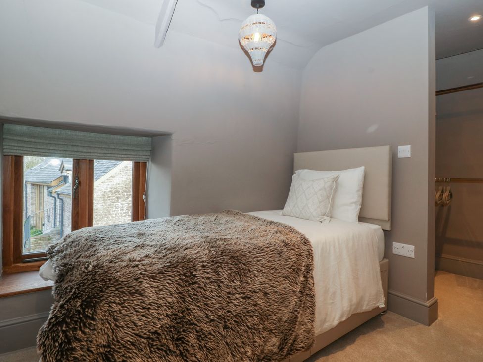 A bedroom with a bed and window at 3 bed property