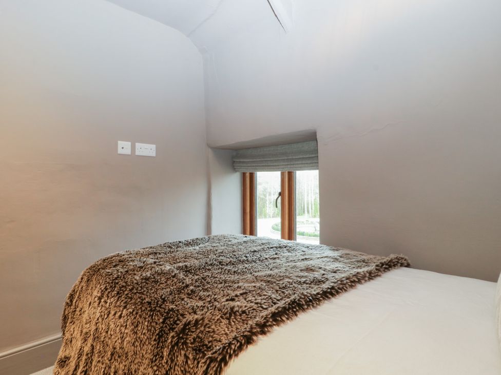 A bedroom with a bed and window at 3 bed property 