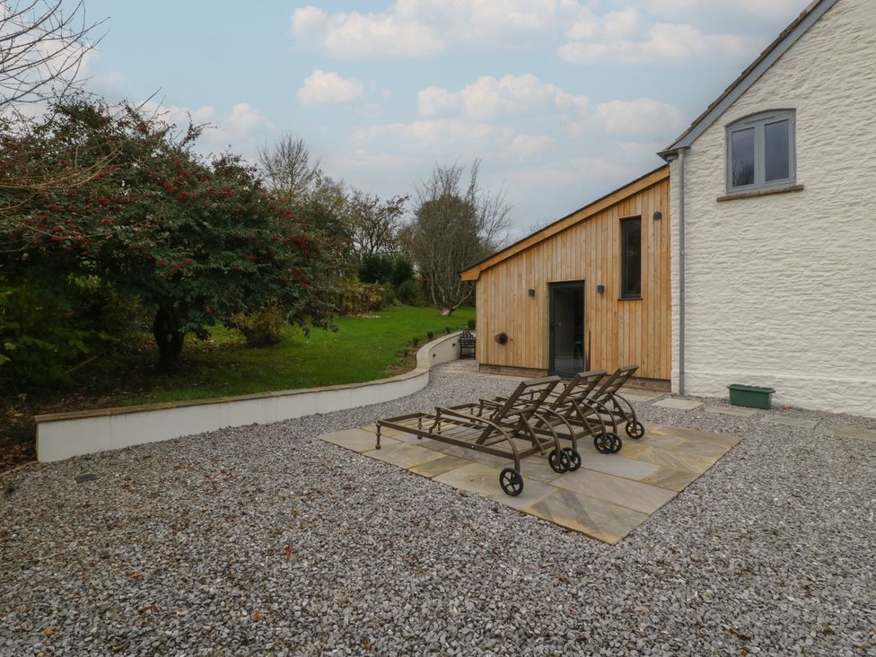 A garden with gravel and sun loungers at 3 bed property