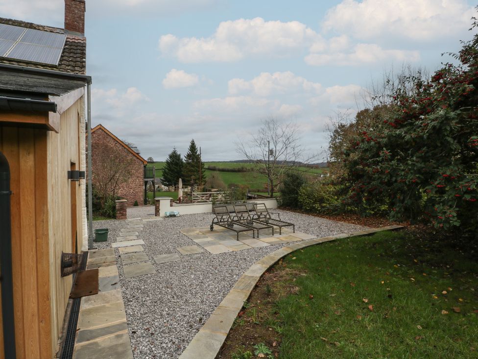 A garden with a gravel patio and seating area at a 3 bed property