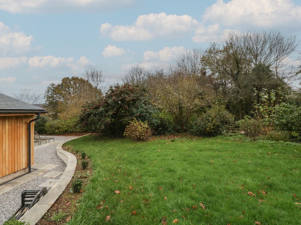 A garden with grass and trees at a 3 bed property 