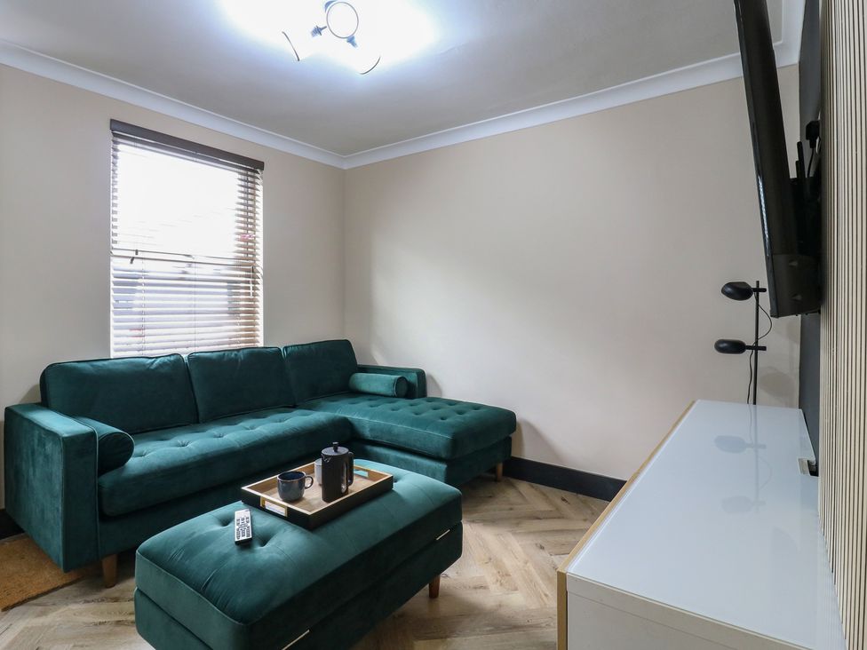 A living room with a green sofa and coffee table at Seibiant in Ramsgate