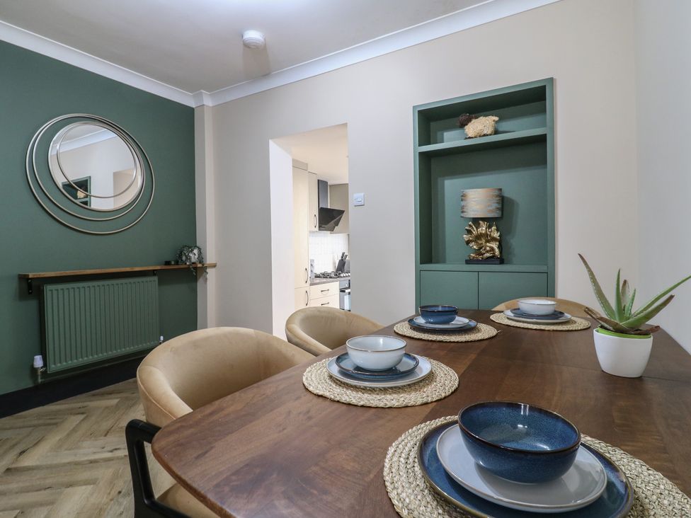 A dining room with a table set with dishes and a mirror at Seibiant in Ramsgate