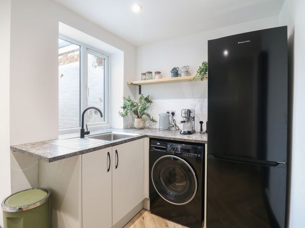 A kitchen with a sink, washing machine and refrigerator at Seibiant in Ramsgate
