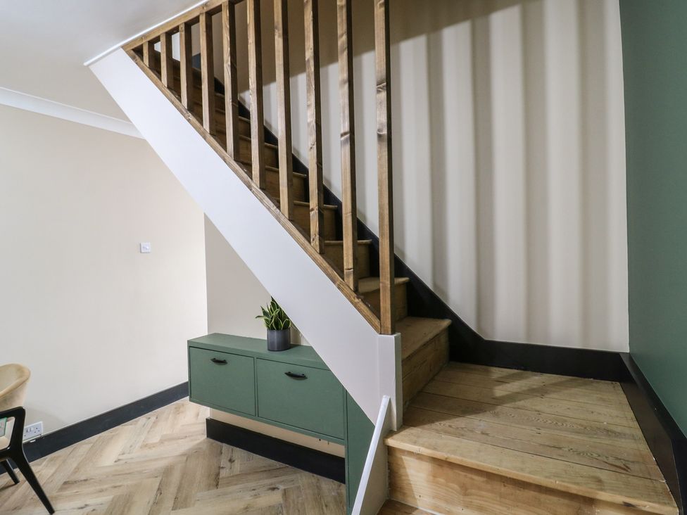 A staircase with wooden railing and a storage unit at Seibiant in Ramsgate