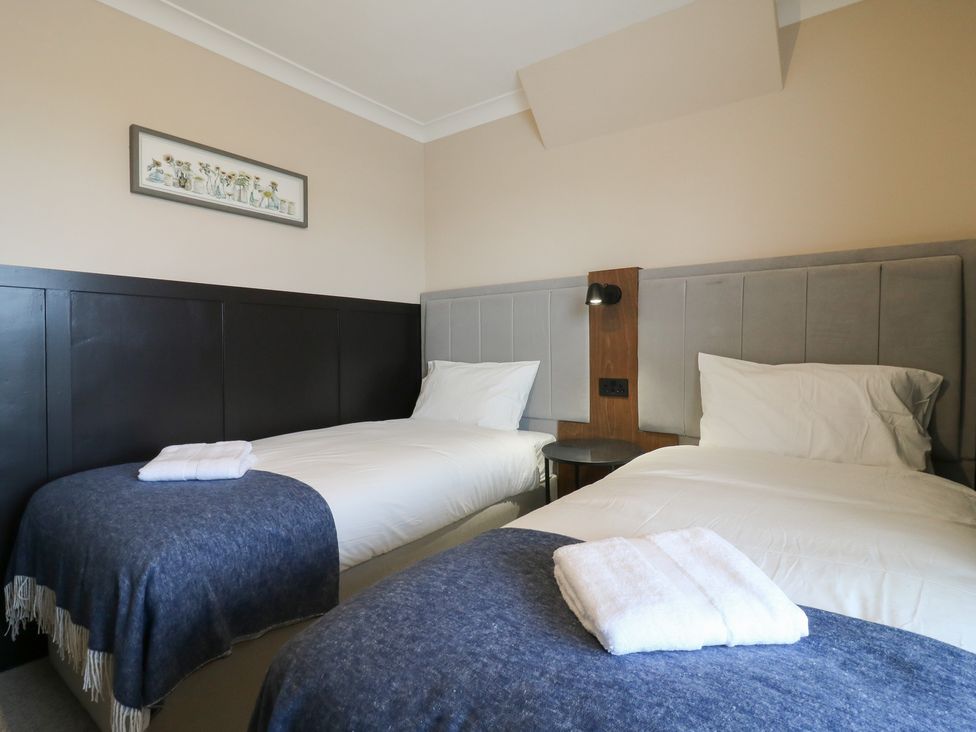 A bedroom with two single beds and a bedside table at Seibiant in Ramsgate