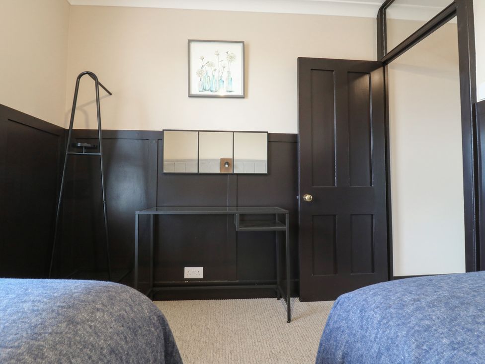 A bedroom with a table and mirror at Seibiant in Ramsgate