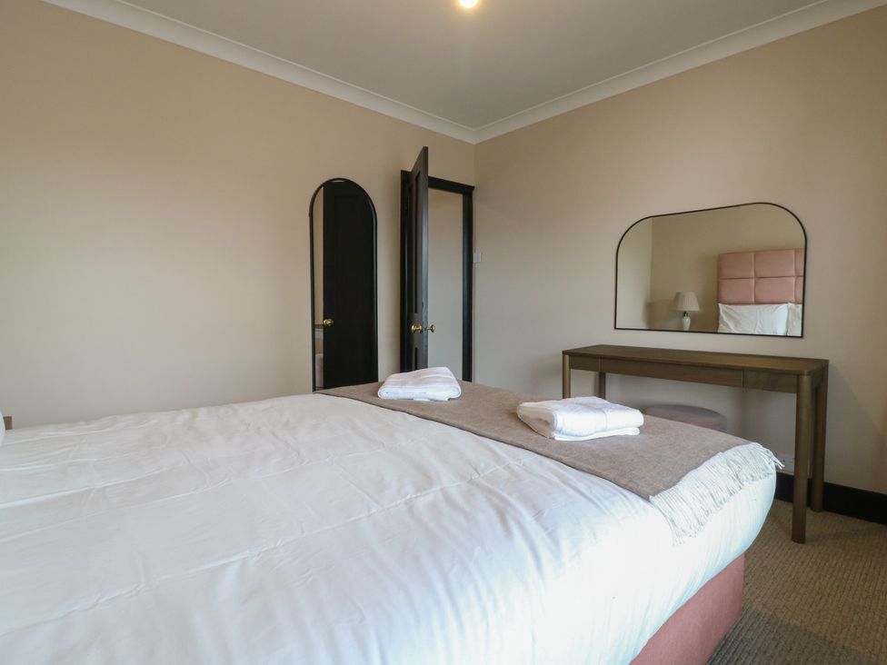 A bedroom with a bed towels and a desk at Seibiant in Ramsgate