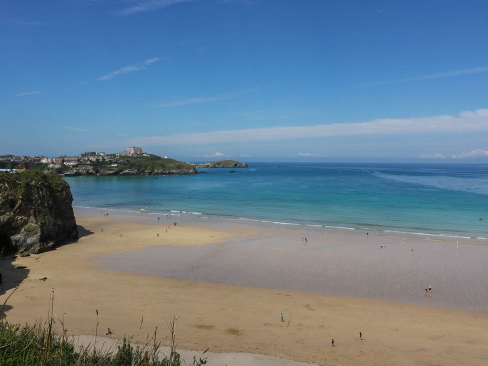 A beach with people and water at Higher Tower Road