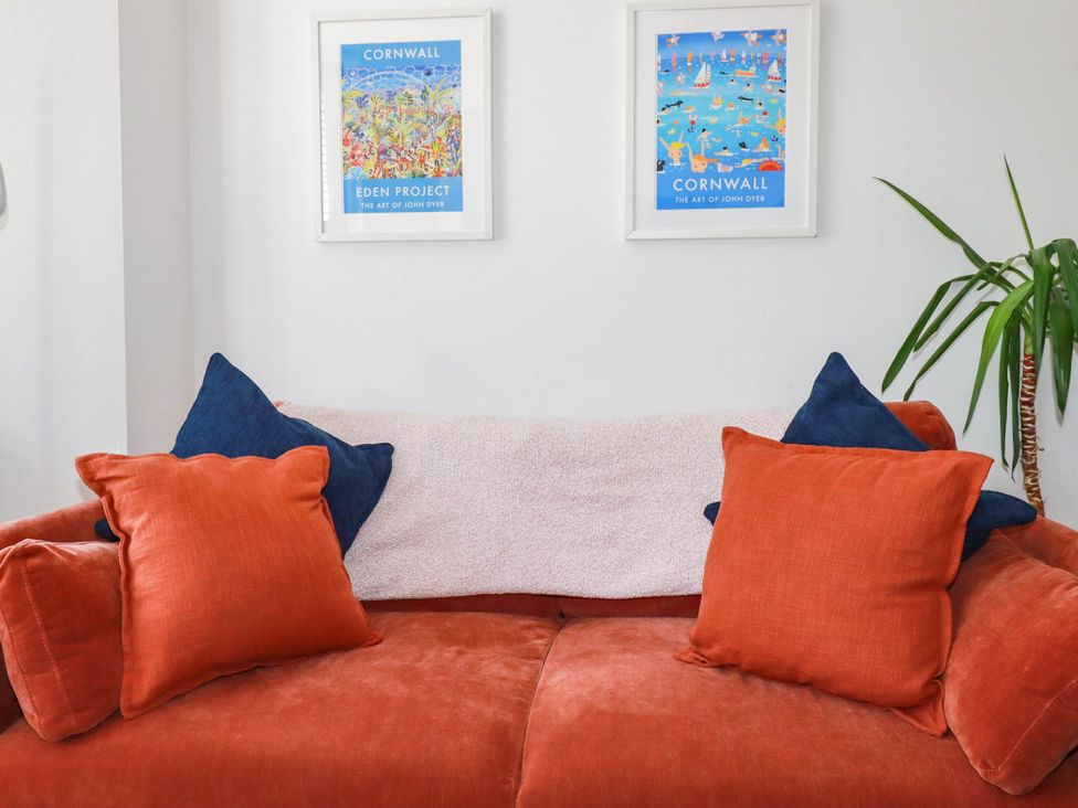 A sofa with pillows and wall art at Higher Tower Road