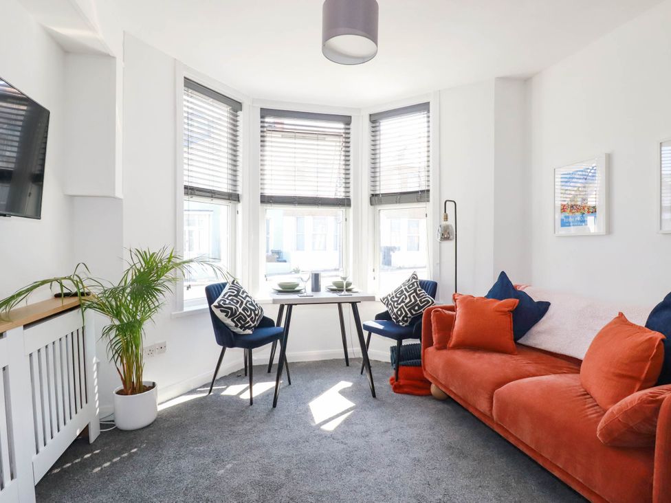 A living room with a sofa and dining table at Higher Tower Road
