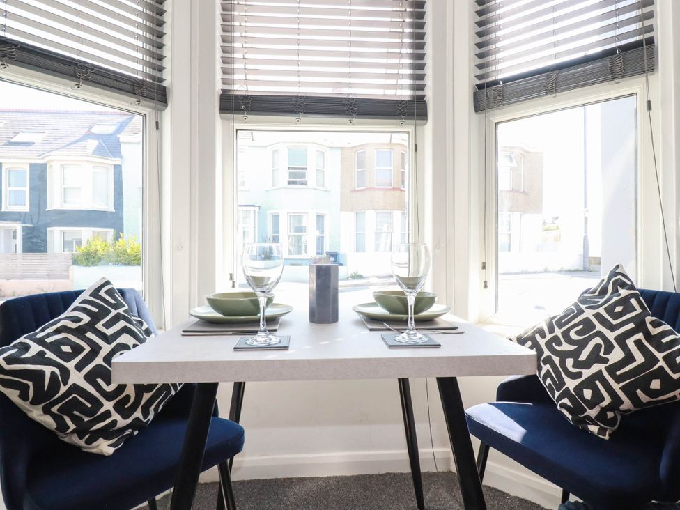 A dining room with a table set for two at Higher Tower Road
