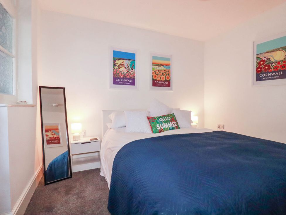 A bedroom with a bed and wall art at Higher Tower Road