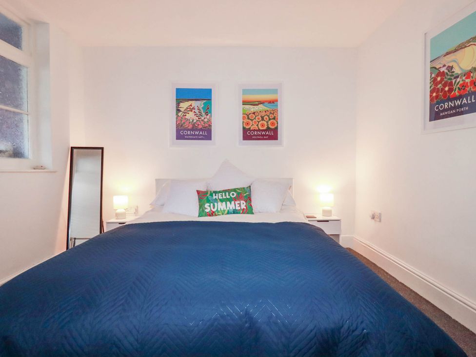 A bedroom with a bed and wall art at Higher Tower Road 