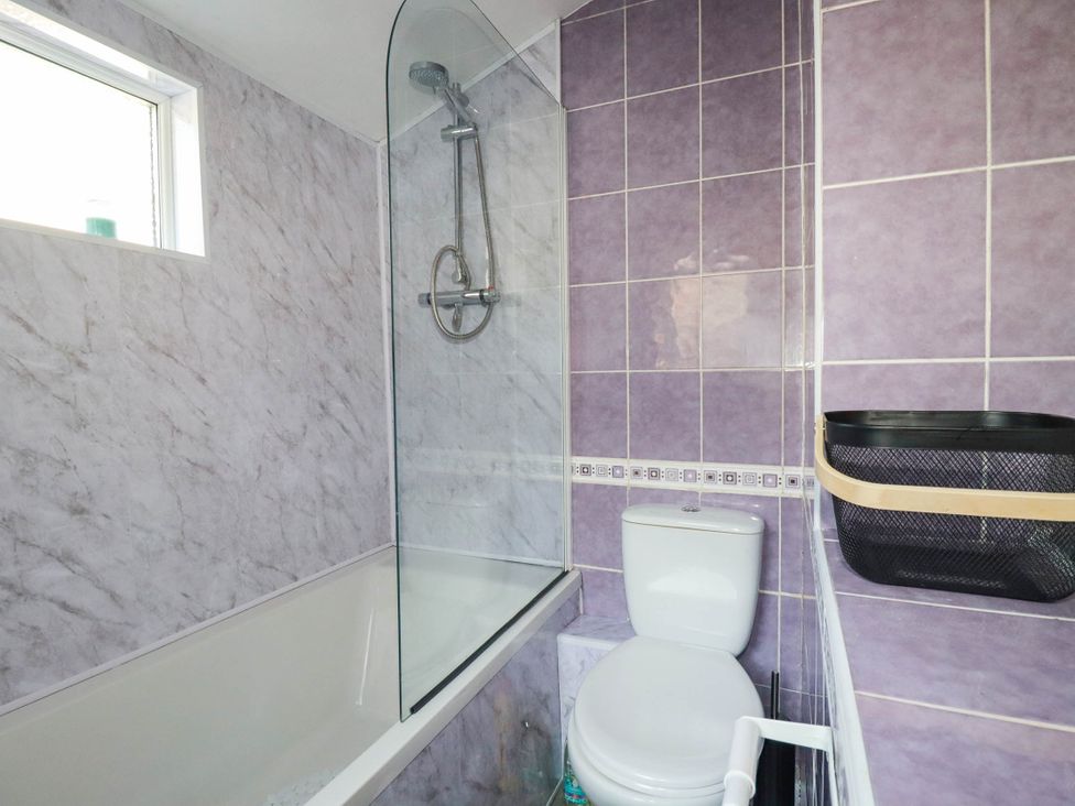 A bathroom with a shower and bathtub at Higher Tower Road 