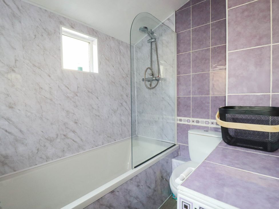 A bathroom with a bathtub, shower, toilet and sink at Higher Tower Road