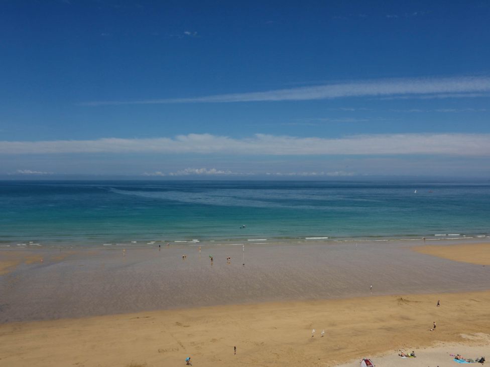 A beach with sand and ocean waves at Higher Tower Road 