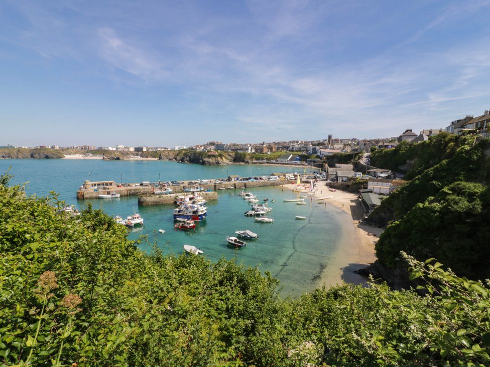 An outdoor view of a harbor with boats and a beach at Higher Tower Road 