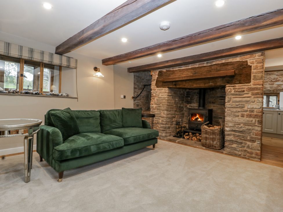 A living room with a fireplace and couch at 1 bed property in Usk