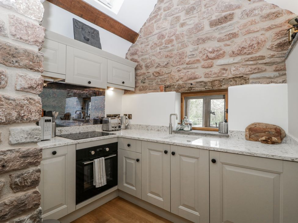A kitchen with cabinets and a sink at 1 bed property in Usk