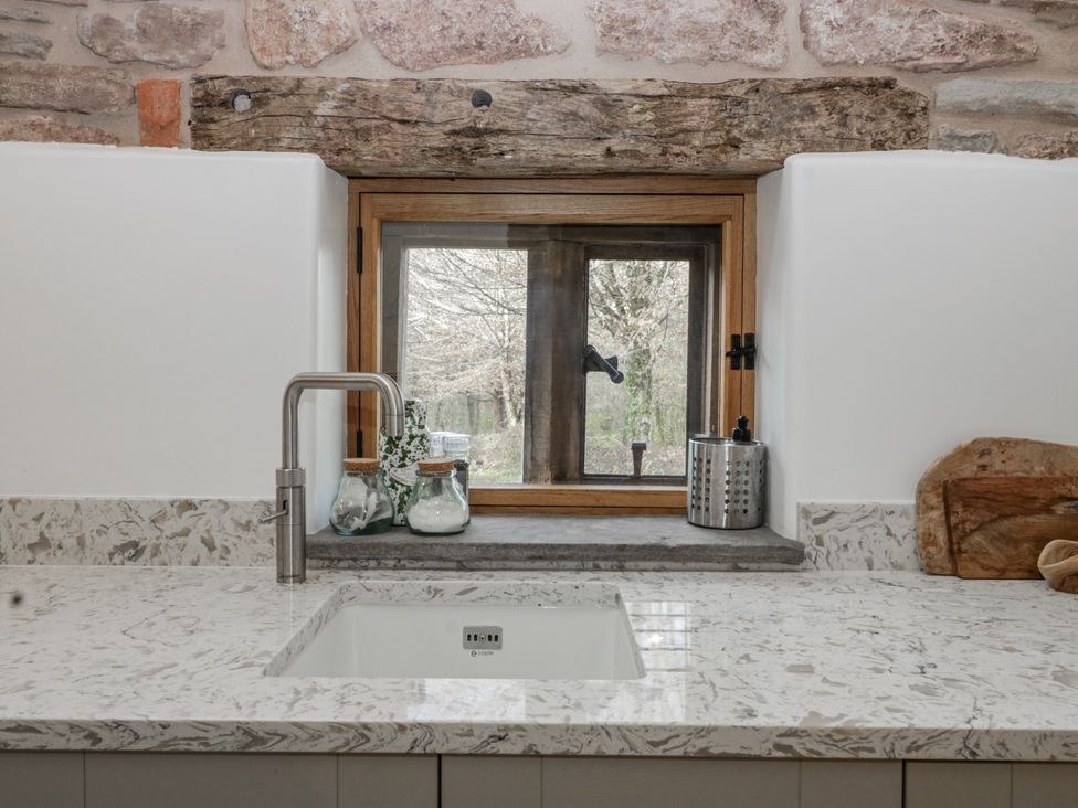 A kitchen with a sink and window at 1 bed property in Usk