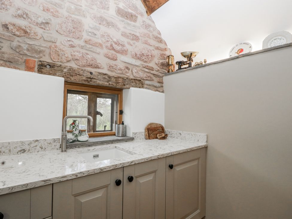 A kitchen with a sink and window at 1 bed property Usk