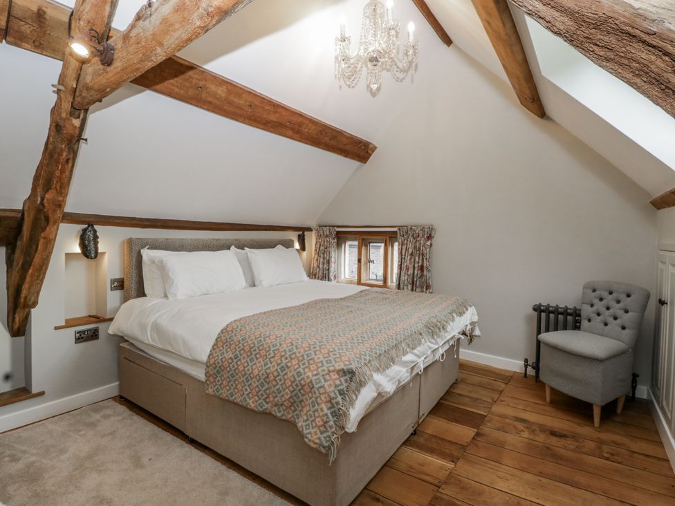 A bedroom with bed and chair at the 1 bed property Usk