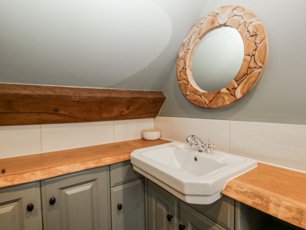 A bathroom with a sink and wooden countertops at 1 bed property in Usk