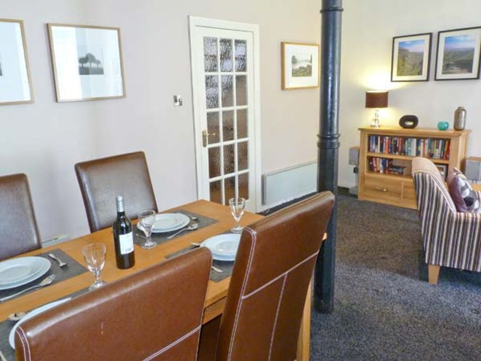 A dining room with a table and chairs at 14 Riverside Walk in Skipton