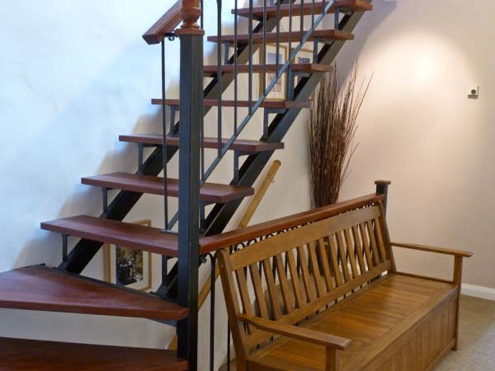 Stairs and a wooden bench in a hallway at 14 Riverside Walk Skipton