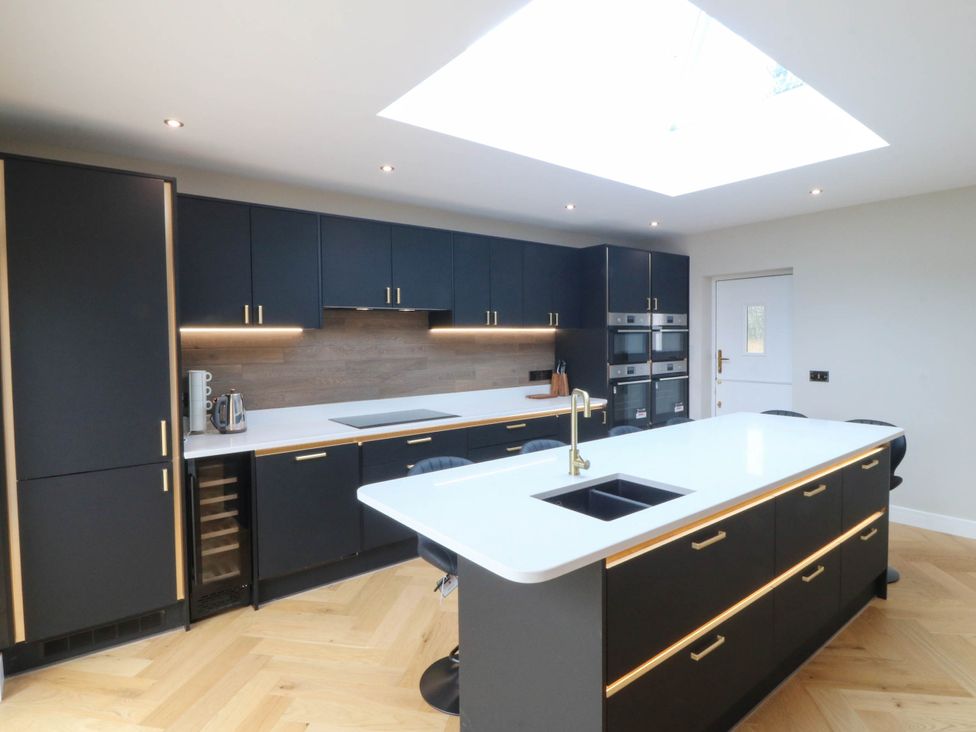 A kitchen with an island and appliances at Angorfa in Pentraeth