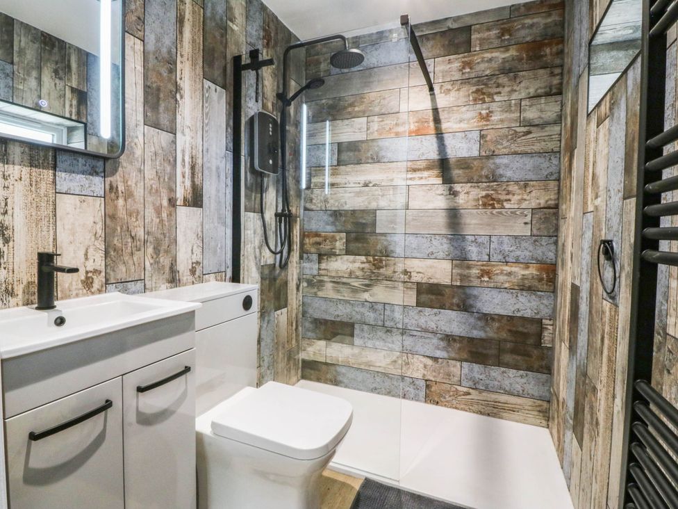 A bathroom with a shower and sink at Angorfa in Pentraeth