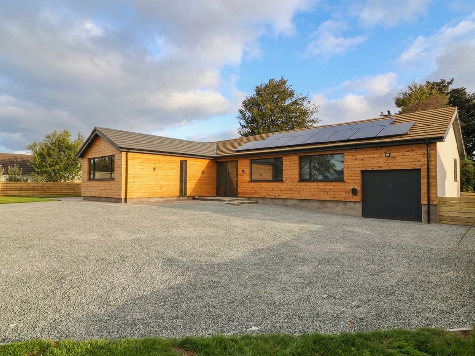 A house with a garage and solar panels at Angorfa in Pentraeth