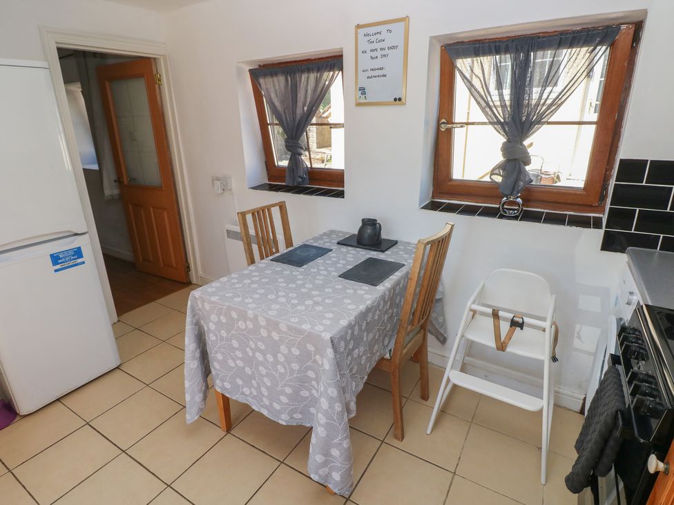 A kitchen with a table and chairs at Tor Cefn Annex in Kidwelly