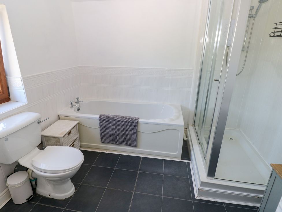 A bathroom with a bathtub and shower at Tor Cefn Annex in Kidwelly